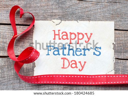 Happy father day on aged paper on wooden background