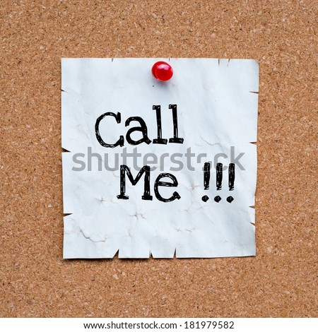 Call me, written on an white sticky note pinned on a cork bulletin board.