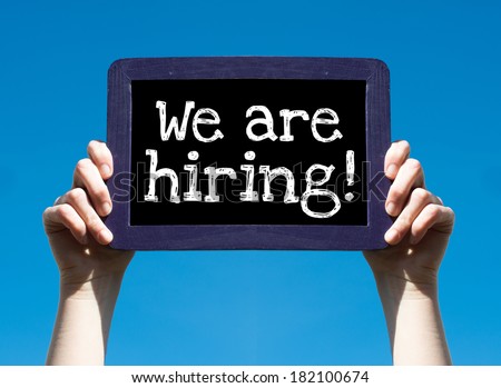 We are hiring ! Woman holding blackboard over blue background with text We are hiring !