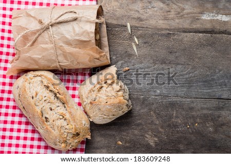 Traditional bread on old wooden table with red cloth