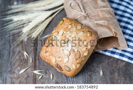 Traditional bread on old wooden table with blue cloth