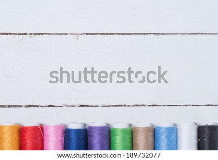Colorful cotton craft threads on wood background with copy space