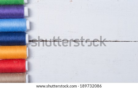 Colorful cotton craft threads on wood background with copy space