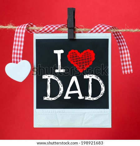 I love Dad message written on old photo hanging on red background