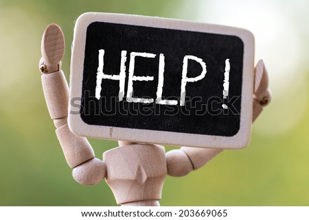 A wooden man holds a slate ready to deliver your message.help