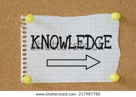 The word Knowledge above an arrow pointing in the right direction on a cork notice board