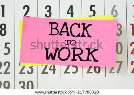 The phrase Back To Work on sticky paper note stuck to a wall calendar background