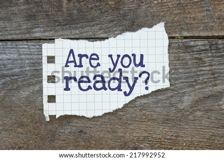 Are you ready written on the paper on a wood background