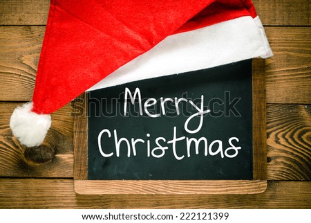 Merry Christmas. Christmas decorations with Christmas hat with place for greeting on chalk blackboard.