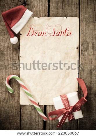 Child letter to Santa Claus. Christmas decorations and old paper with place for greeting on old paper blackboard.