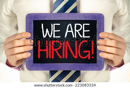 We are hiring ! Man holding blackboard with text We are hiring !