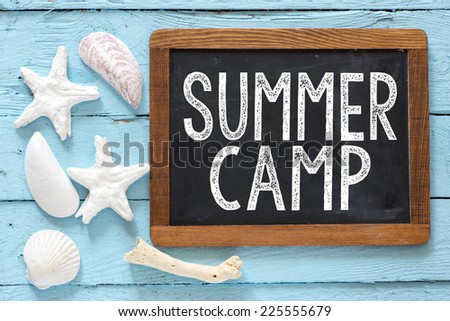 Sea travel frame decor with seashells over wooden background with small blackboard with text Summer camp