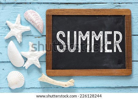 Sea travel frame decor with seashells over wooden background with small blackboard with text Summer