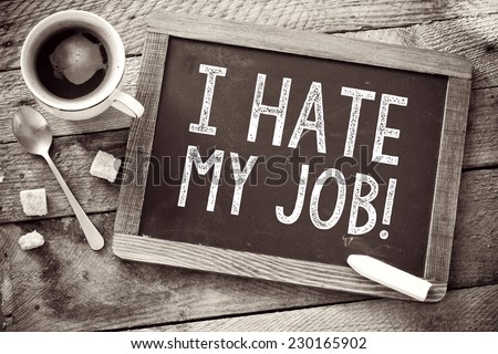 Blackboard with I Hate My Job sign and cup of coffee on wooden background