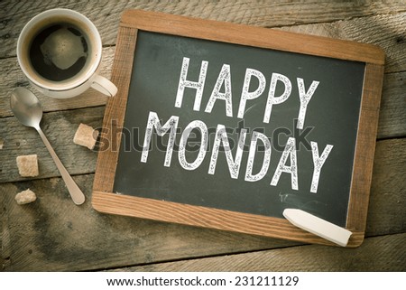 Happy Monday. Blackboard with Happy Monday sign and cup of coffee on wooden background