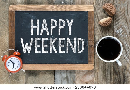 Happy weekend sign on blackboard with cup of coffee ,cookie and clock on wooden background