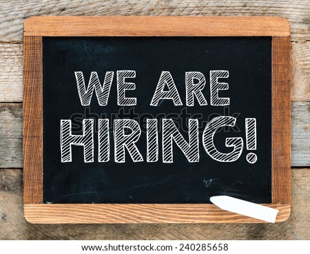 We are hiring background. We are hiring handwritten with white chalk on a blackboard