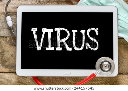 Tablet pc with word Virus. Tablet pc with word Virus and stethoscope, medicine concept