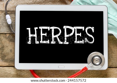Tablet pc with word Herpes. Tablet pc with word Herpes and stethoscope, medicine concept