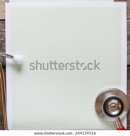 Paper note with stethoscope. Paper note with stethoscope on wooden table