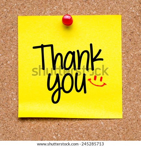 Note with Thank you. Blank yellow sticky note with Thank you sign and smile pined on a cork bulletin board.