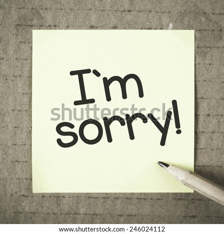 Note with I\'m sorry. Note with I\'m sorry and pencil on grunge background