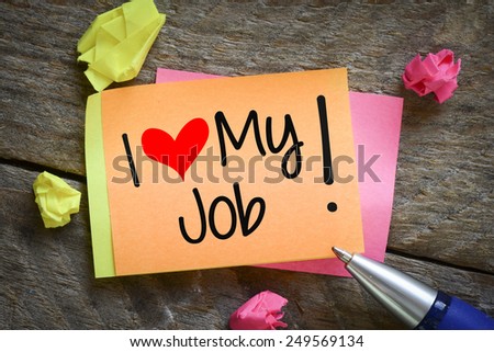 Note with I love my job. Note with I love my job on the wooden background with pen