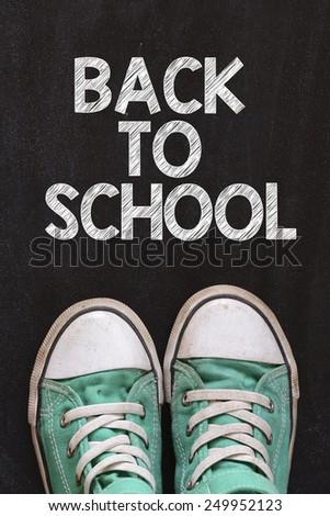 Male sneakers and back to school. Male sneakers on the asphalt road with drawn back to school
