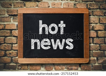 Hot news on Blackboard. Hot news on Blackboard on bricks wall