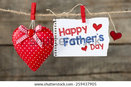 Happy fathers day message. Happy fathers day message written on paper ,handling on rope with hearts