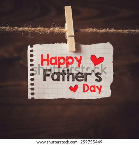 Happy fathers day message. Happy fathers day message written on paper handling on rope with hearts