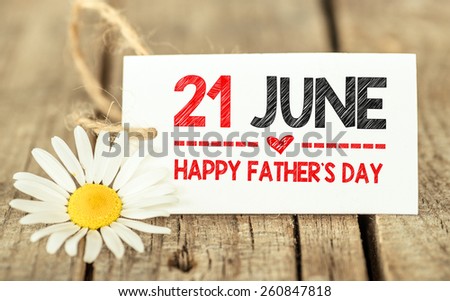 21 June, flowers and label Happy fathers day. Flowers and label Happy fathers day on wooden background.