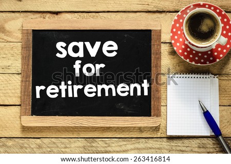 Safe for retirement on blackboard. Safe for retirement On blackboard with cup of coffee, notebook and pen on wooden background
