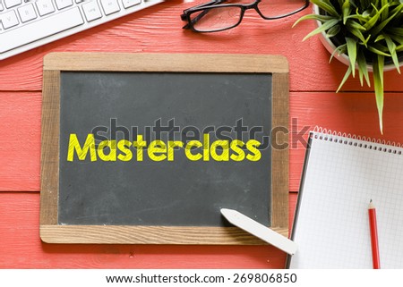 Master class handwritten on blackboard. Master class Handwritten with chalk on blackboard, keyboard,notebook,glasses and green plant on wooden background