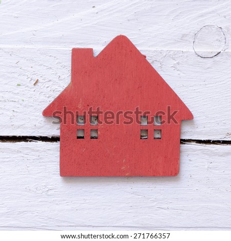 Red Toy wooden house on wooden background