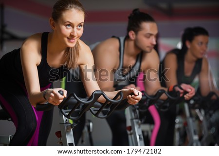 People doing indoor biking in a fitness club