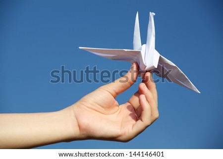 hand holding origami bird.