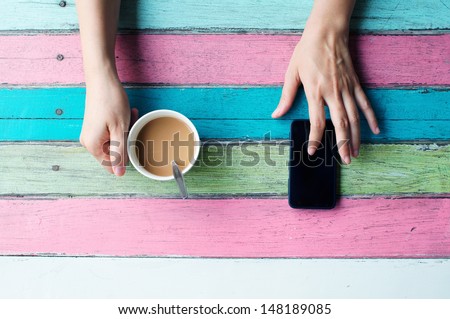 Hand Holding Coffee Cup And Using Smart Phone
