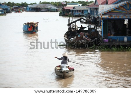 SIEM REAP, CAMBODIA AUG 12: Cambodian people live beside Tonle Sap Lake in Siem Reap, Cambodia on august 12, 2013. This is the largest freshwater lake in SE Asia peaking. Annual flooding of the village.