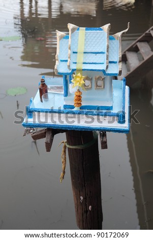 Thai outdoor spirit house shrine. In modern Thailand all spirit houses are kept outdoor. This one is made in the Thai Buddhist temple (wat) style.