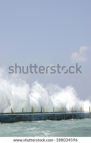 high wave breaking on the breakwater on the coast