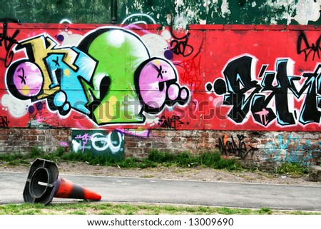 wall of graffiti with abandoned cone