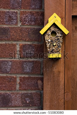 Bird seed in the shape of a bird house