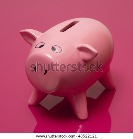 piggy bank style money box on a bright pink studio background.
