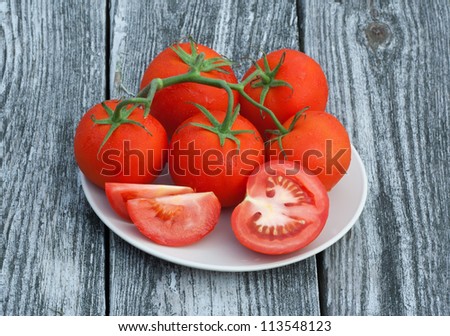 Plate with tomatoes on reclaimed wood background