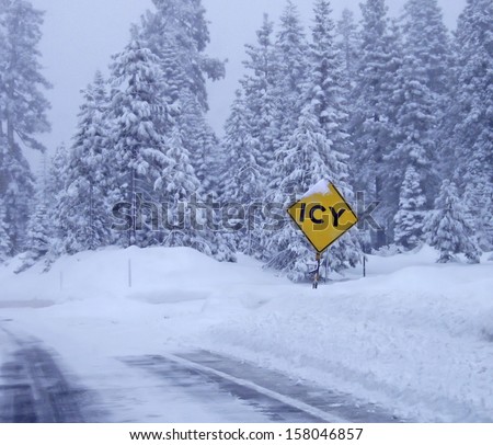Landscape with road in winter forest and road sign \