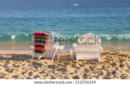 Two beach chairs with mexican blanket  near ocean