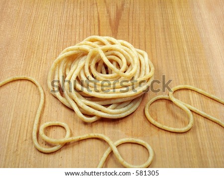 Cooked whole wheat pasta on cedar board