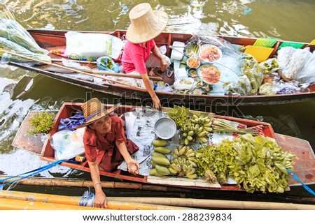 Bangkok, Thailand - April 15,2015: Old woman selling fruits and vegetables in a traditional floating market