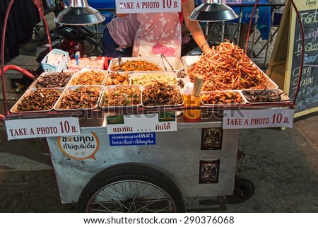 Bangkok, Thailand - April 17,2015: A street vendor selling fried insects to tourists on Khao San Road in Bangkok